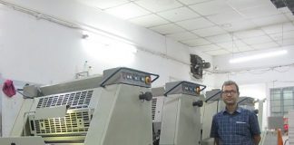 Nand Kishor Singh, director at Megalith PrintCare, standing with a 4-color Adast Dominant 745 C offset printing machine. Photo: PSA